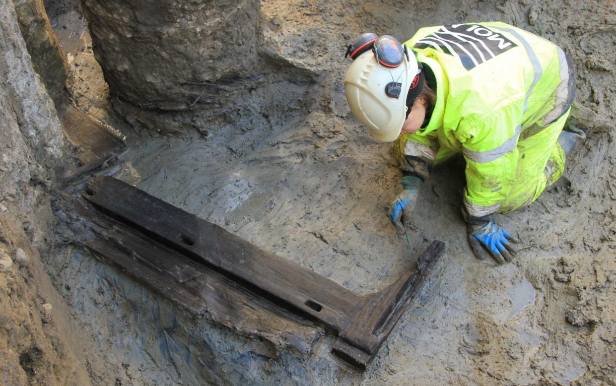 An archaeologist excavating the funerary bed