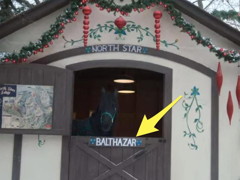 yellow arrow pointing to the name bathazar on a horse's stable in falling for christmas