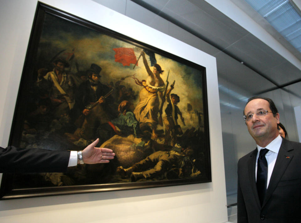 France's President Francois Hollande is seen in front of " La Liberte Guidant le Peuple", a painting by Eugene Delacroix during the inauguration of the Louvre Museum in Lens, northern France, Tuesday, Dec. 4, 2012. The museum in Lens is to open on Dec. 12, as part of a strategy to spread art beyond the traditional bastions of culture in Paris to new audiences in the provinces. (AP Photo/Michel Spingler, Pool)