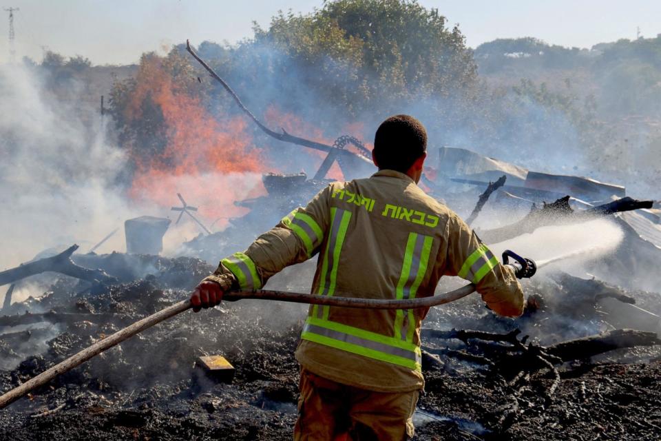 PHOTO: An Israeli firefighter puts out flames in a field after rockets launched from southern Lebanon landed on the outskirts of Kiryat Shmona, on June 4, 2024, amid ongoing cross-border clashes between Israeli troops and Hezbollah fighters. (Jack Guez/AFP via Getty Images)