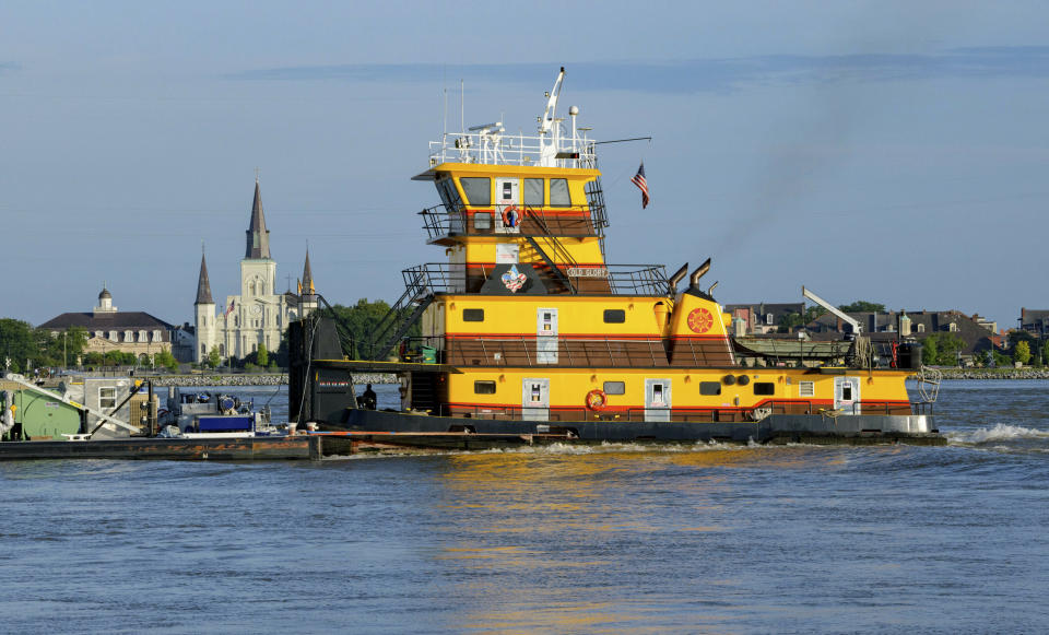 The Old Glory towing vessel appears taller than St. Louis Cathedral in the French Quarter as the Mississippi River is currently above 16 feet, which is just below flood stage at 17 feet, in New Orleans, Thursday, July 11, 2019 ahead of Tropical Storm Barry from the Gulf of Mexico. The river levees protect to about 20 feet, which the river may reach if predicted storm surge prevents the river from flowing into the Gulf of Mexico. (AP Photo/Matthew Hinton)