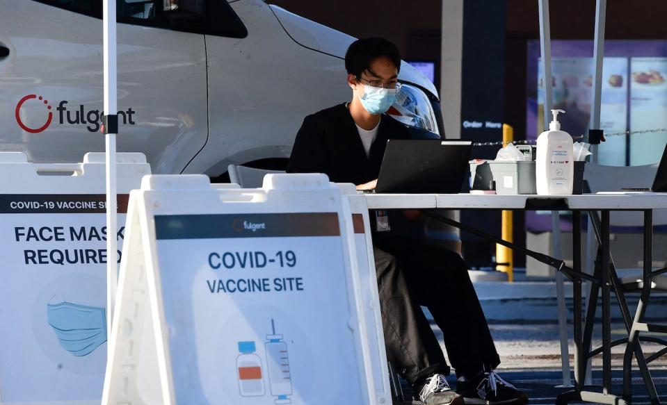 A mandate will get some vaccine holdouts to get the shot. <a href="https://www.gettyimages.com/detail/news-photo/health-care-worker-awaits-those-wanting-the-covid-19-news-photo/1235410337" rel="nofollow noopener" target="_blank" data-ylk="slk:Frederic J. Brown/AFP via Getty Images;elm:context_link;itc:0;sec:content-canvas" class="link ">Frederic J. Brown/AFP via Getty Images</a>