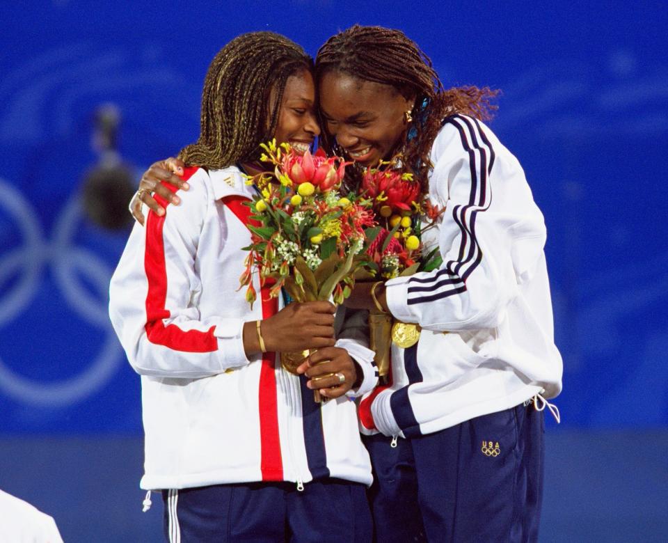 <p>Venus and Serena Williams of the USA celebrate gold after winning the Womens Doubles Tennis Final at the NSW Tennis Centre on Day 13 of the Sydney 2000 Olympic Games in Sydney, Australia. Mandatory Credit: Gary M Prior/Allsport </p>