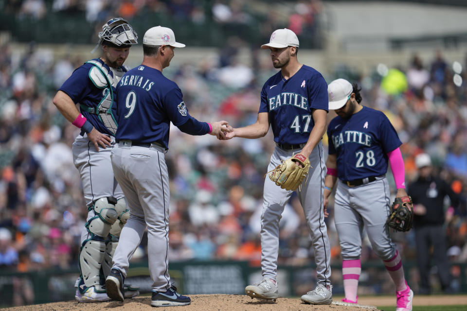 Seattle Mariners manager Scott Servais (9) takes the ball from relief pitcher Matt Brash (47) in the seventh inning of a baseball game, Sunday, May 14, 2023, in Detroit. (AP Photo/Paul Sancya)