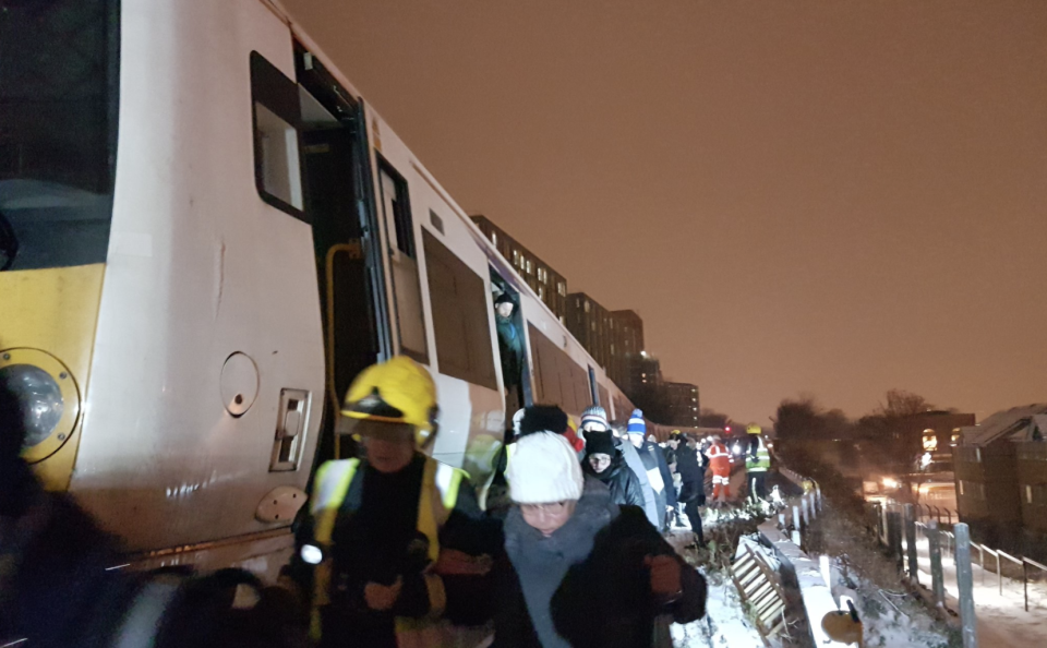 Passengers had to eventually be escorted away from the stationary train by emergency services. (Twitter/Eleanor Mawrey)