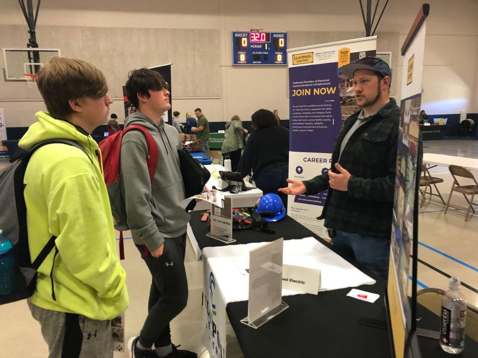 Jesse Mitchell of Claypool Electric talks with students Kyler Morris and Wesley Higgins about job opportunities and training, during the job fair held last week at Licking Valley High School.