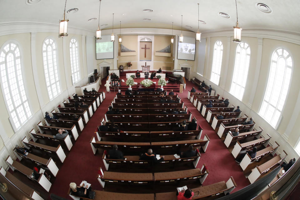 Mourners sit spaced apart for social distancing during a funeral service for Rev. C.T. Vivian Thursday, July 23, 2020, in Atlanta. (AP Photo/John Bazemore)