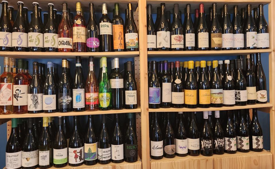 The wine rack at Little Sister features a wide range of bottles.