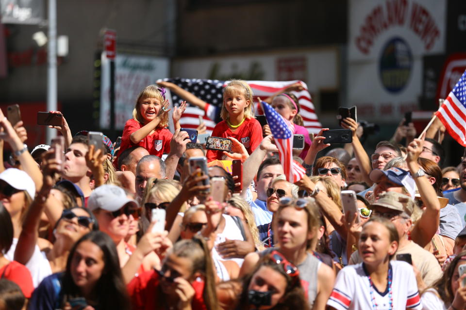 Fans celebrate as members of the U.S. women's soccer team pass by during a ticker tape parade along the Canyon of Heroes, Wednesday, July 10, 2019, in New York. (Photo: Gordon Donovan/Yahoo News)