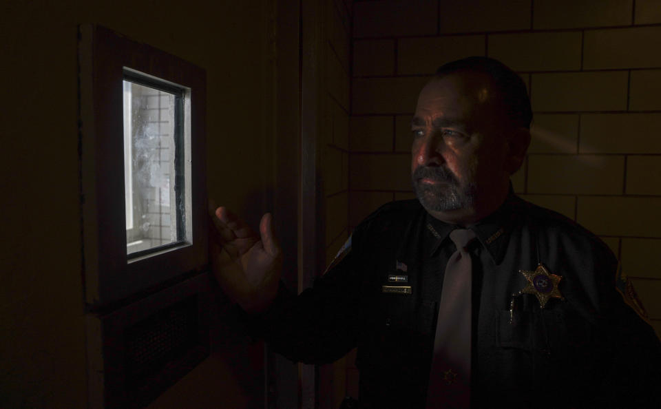 Dane County, Wis., Sheriff David Mahoney looks through a small window in a solitary confinement cell at the county jail in Madison. Mahoney says he has no separate housing for inmates with certain behavioral, medical or mental health problems, so he has to put them in these cells even though he says it's "inhumane. But we're forced into a situation to keep these people alive." (AP Photo/Morry Gash)