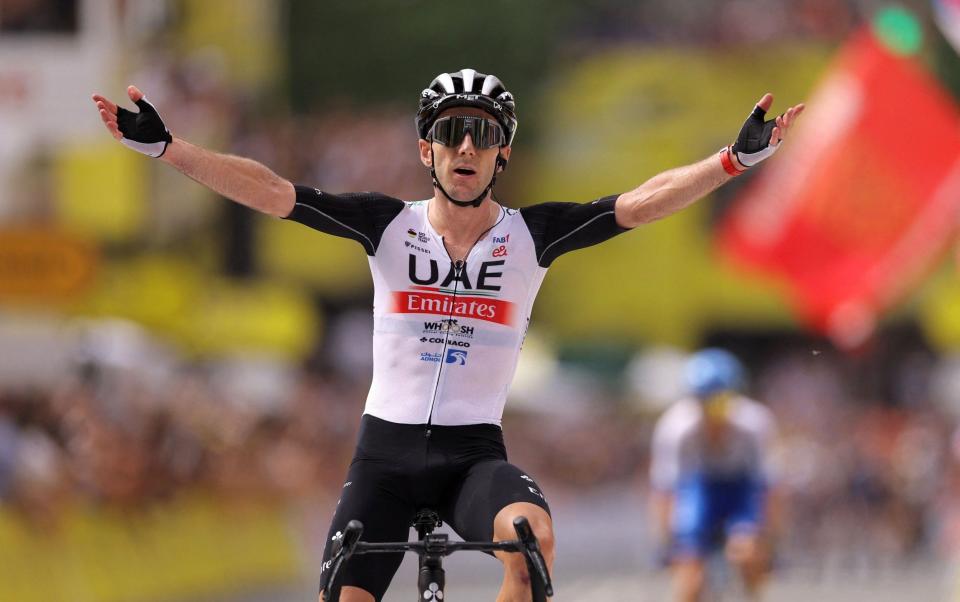 UAE Team Emirates' Adam Yates celebrates winning a thrilling first stage to take the yellow jersey