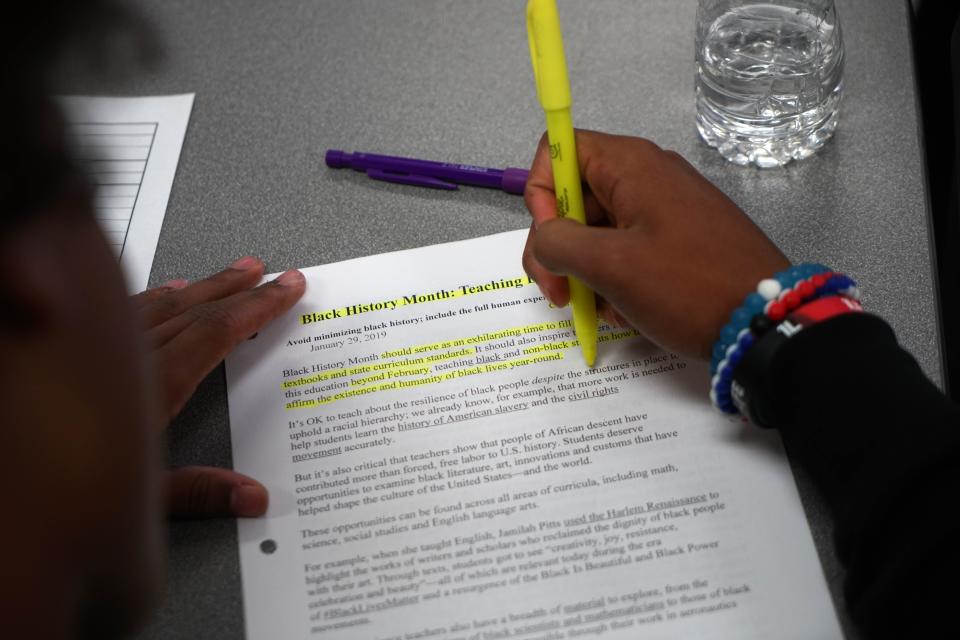 A student at Mt. Pleasant High School highlights points in a reading assignment in an African American studies course.