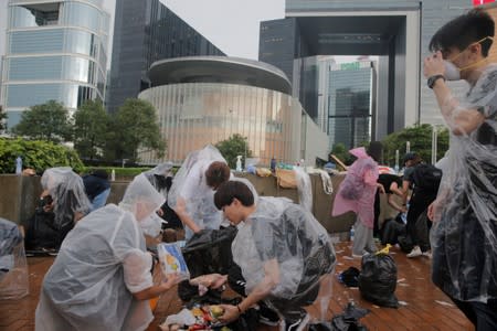 People clear rubbish outside the Legislative Council building after violent clashes in Hong Kong