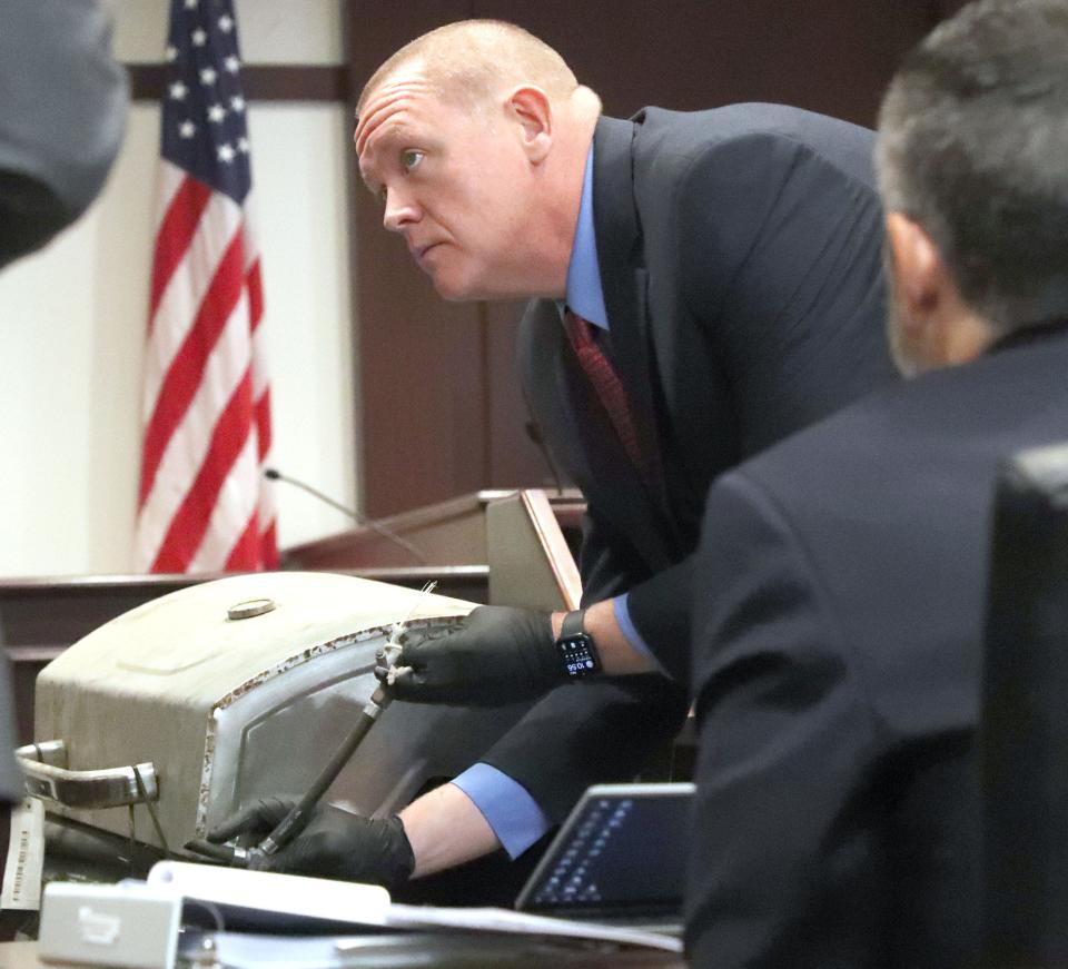 Volusia County Sherriff's Office Investigator Joshua Mott shows the BBQ grill Friday, June 2, 2023, that Robert Remus Jr. is accused of using to weigh down his father's body in the St. Johns River after killing him in 2012. Remus Jr. is on trial for his father's death.