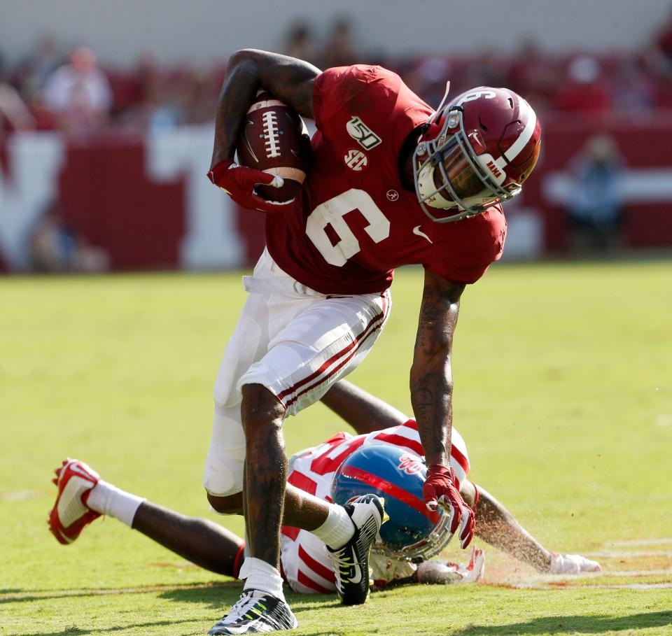 Alabama wide receiver DeVonta Smith (6) evades a tackle on his way to scoring a touchdown during the first half of Alabama's game with Ole Miss Saturday, Sept. 28, 2019. [Staff Photo/Gary Cosby Jr.]