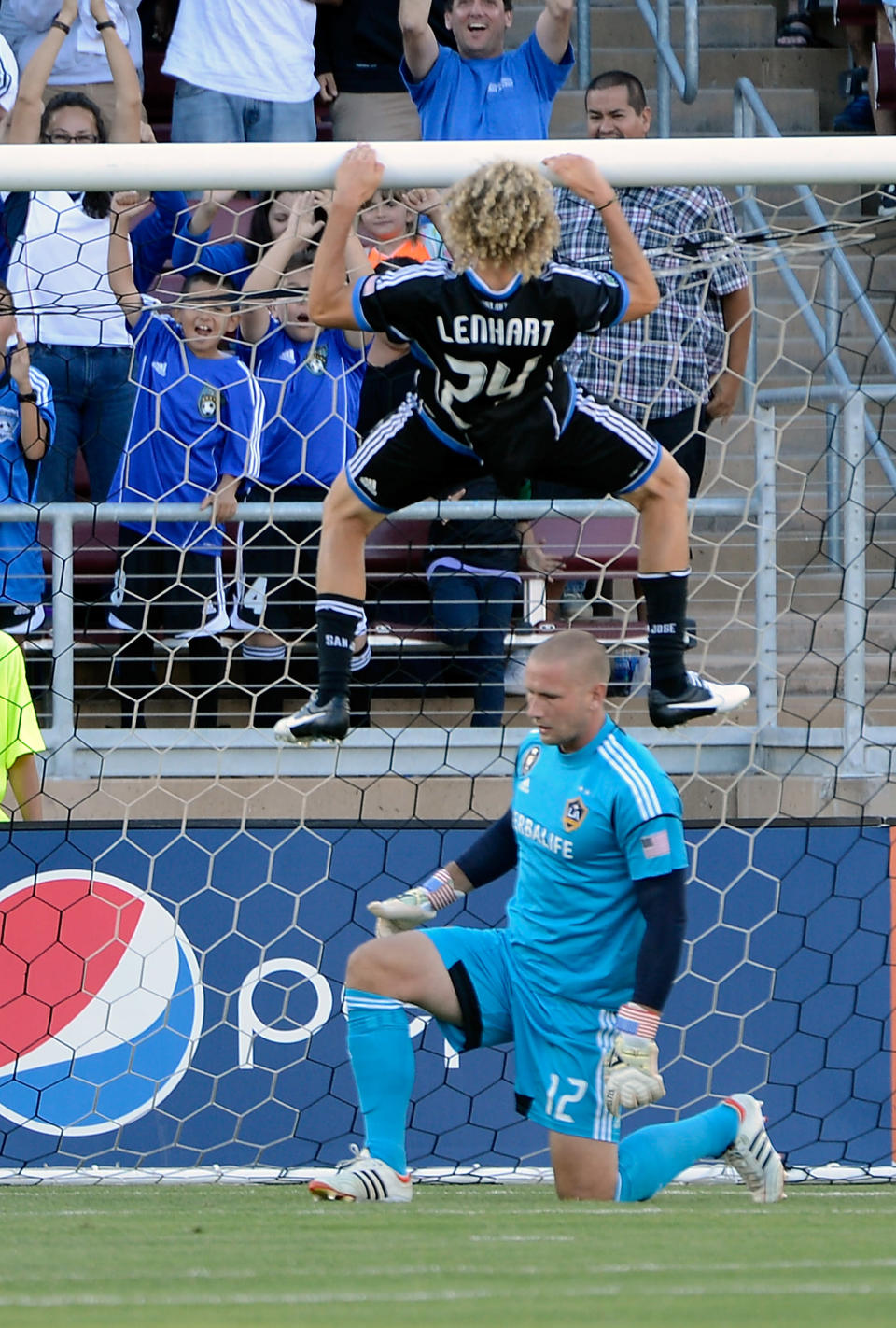 PALO ALTO, CA - JUNE 30: Steven Lenhart #24 of the San Jose Earthquakes scores a goal and celebrates by doing pullups over the head of goal keeper Josh Saunders #12 of the Los Angeles Galaxy in the first half of their MLS game at Stanford Stadium on June 30, 2012 in Palo Alto, California. (Photo by Thearon W. Henderson/Getty Images)