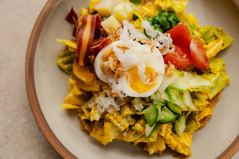 The Wolf's gado-gado Cobb salad includes egg, corn, green beans, potato, tomato, toasted coconut, puffed rice cracker and peanut dressing.