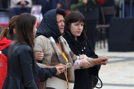 People mourn during a memorial ceremony before the funeral of victims of an attack on a local college in the city of Kerch, Crimea October 19, 2018. REUTERS/Pavel Rebrov