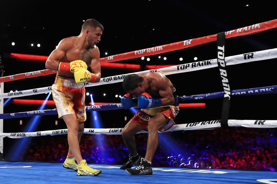 Vasyl Lomachenko (L) puts the finishing touches on Miguel Marriaga Saturday in their WBO super featherweight title bout at the Microsoft Theater in Los Angeles. (Getty Images)
