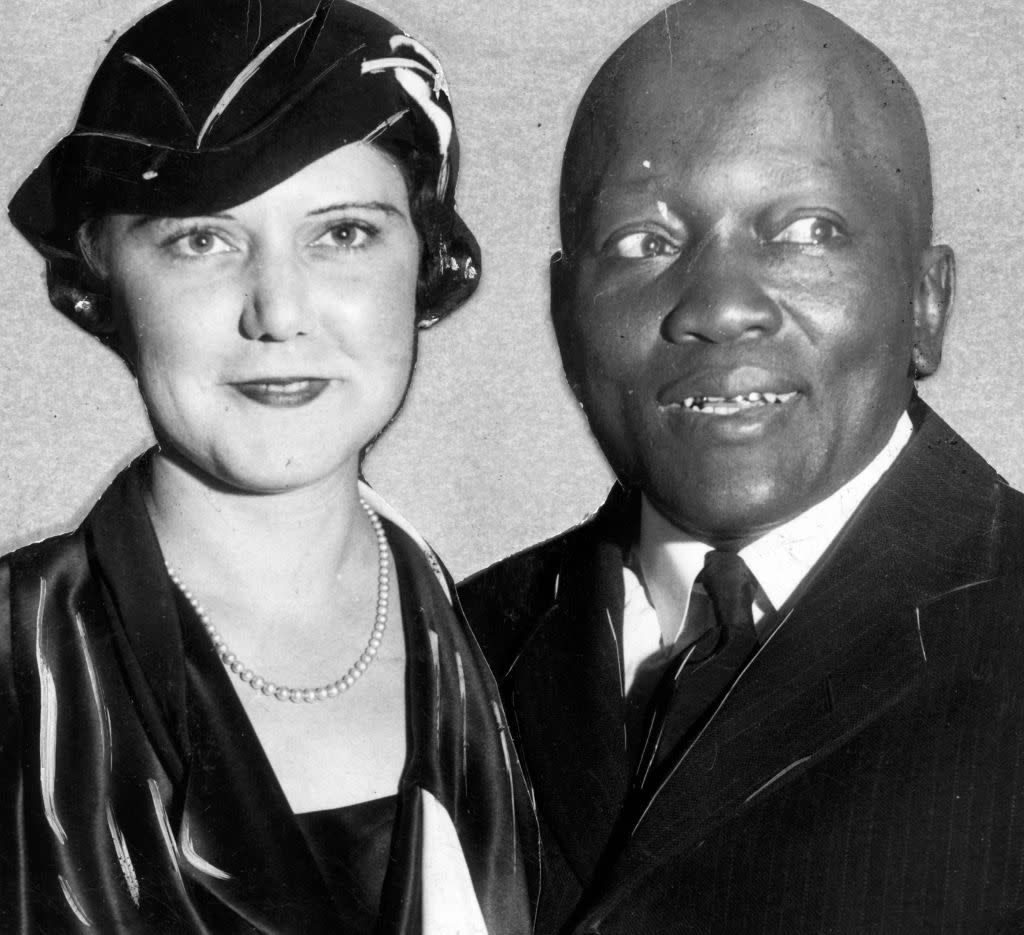 Jack Johnson – the first Black heavyweight boxing champion of the world with wife Lucille Cameron in 1920. They had lived in exile following his 1912 arrest for crossing a state line with Cameron in the car. After his 1920 return to the US, he was imprisoned for the crime. (Photo by Afro American Newspapers/Gado/Getty Images).<br>To the left is a 1912 <em>New York Times</em> article reporting that Johnson led a syndicate of “wealthy negroes” that planned an “invasion of the fashionable resorts of the white race”.