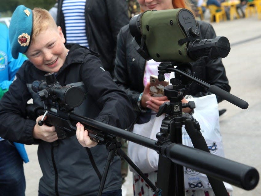 boy with a machine gun during celebrations marking Day of the Russian Airborne Troops, on August 2, 2019.