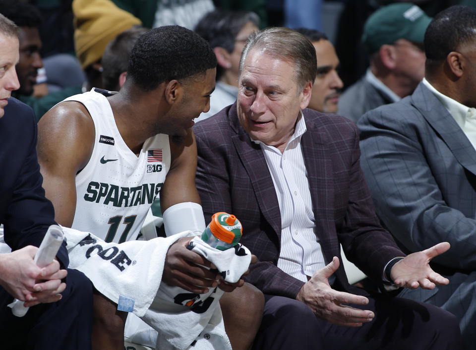 Michigan State coach Tom Izzo, right, talks with Aaron Henry on the bench during the second half of an NCAA college basketball game against Eastern Michigan, Saturday, Dec. 21, 2019, in East Lansing, Mich. (AP Photo/Al Goldis)