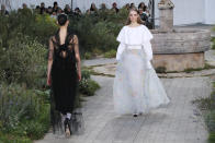 Models wear creations for the Chanel Haute Couture Spring/Summer 2020 fashion collection presented Tuesday Jan. 21, 2020 in Paris. (AP Photo/Francois Mori)