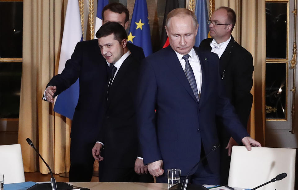 FILE - Russian President Vladimir Putin, right, and Ukrainian President Volodymyr Zelenskyy arrive for a working session at the Elysee Palace, Dec. 9, 2019, in Paris. (Ian Langsdon/Pool via AP, File)