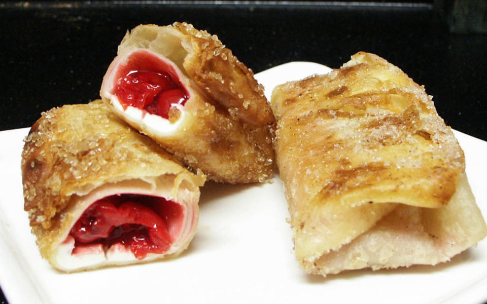 <p>Ben Rayl</p><p>Cream cheese and cherry pie filling in a crispy shell dusted with cinnamon sugar.</p><p><strong>Get the recipe: <a href="https://parade.com/260145/benrayl/cherry-pie-chimichangas/" rel="nofollow noopener" target="_blank" data-ylk="slk:Cherry Pie Chimichangas;elm:context_link;itc:0;sec:content-canvas" class="link ">Cherry Pie Chimichangas</a></strong></p>