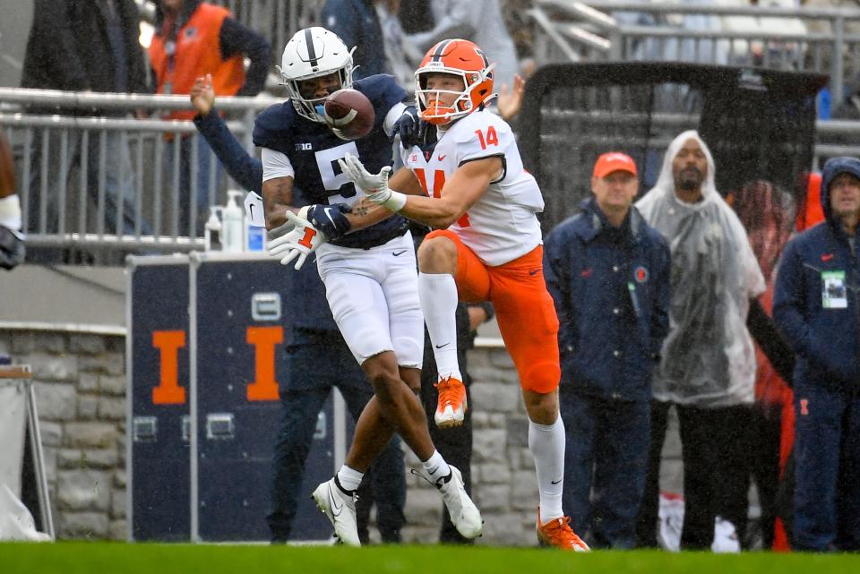 Penn State cornerback Tariq Castro-Fields (5) breaks up a pass intended for Illinois wide receiver Casey Washington (14) during the first half at Beaver Stadium.