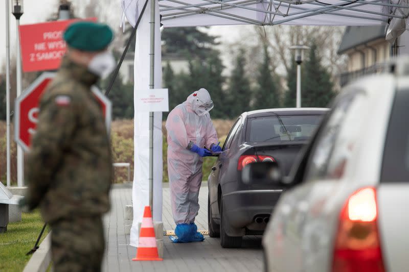 A staff member works at a mobile coronavirus disease (COVID-19) test centre in Warsaw