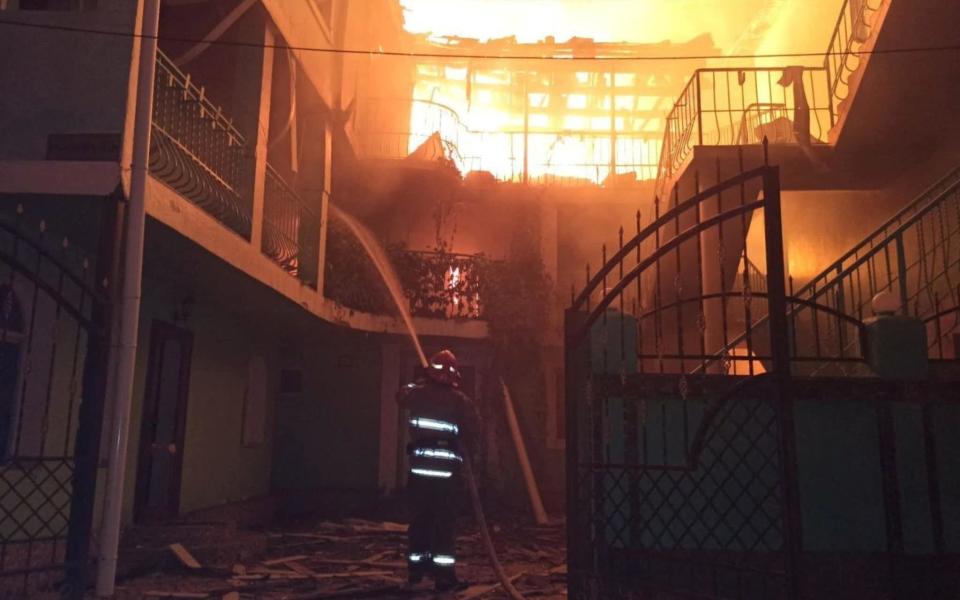 A firefighter works at a site of a hotel building hit by a Russian missile strike in a resort area in Odesa region, as Russia's attack on Ukraine continues - Reuters