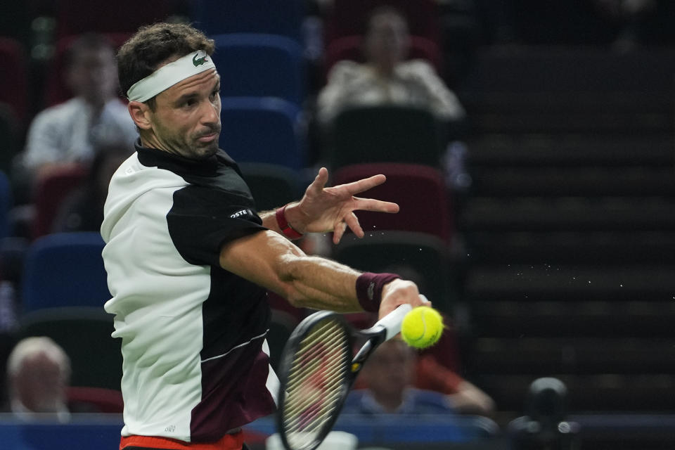 Grigor Dimitrov of Bulgaria returns a shot to Andrey Rublev of Russia during the men's singles semifinal match in the Shanghai Masters tennis tournament at Qizhong Forest Sports City Tennis Center in Shanghai, China, Saturday, Oct. 14, 2023. (AP Photo/Andy Wong)