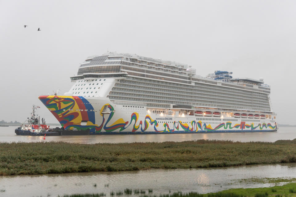 01 October 2019, Lower Saxony, Terborg: The "Norwegian Encore" as the newest cruise giant of the Meyer shipyard in Papenburg is being transported slowly backwards, pulled by tugs, on the Ems into the North Sea. The ship has room for 4,000 passengers. The ship is due to be handed over to Norwegian Cruise Lines in Bremerhaven at the end of October. Photo: Martin Remmers/dpa (Photo by Martin Remmers/picture alliance via Getty Images)