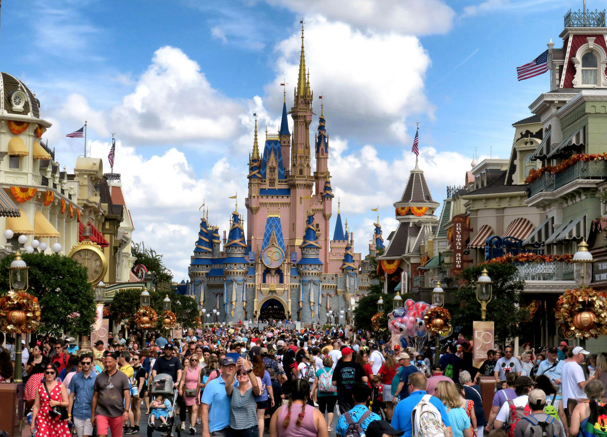 Crowds fill Main Street USA in front of Cinderella Castle at the Magic Kingdom on the 50th anniversary of Walt Disney World, in Lake Buena Vista, Florida, on Oct. 1, 2021. (Joe Burbank/Orlando Sentinel/Tribune News Service via Getty Images)