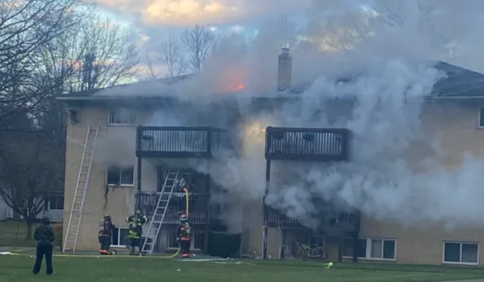 Firefighters fight a reported arson fire at a Ravenna apartment building Sunday.