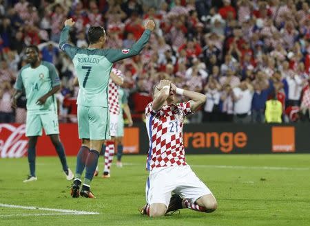 Football Soccer - Croatia v Portugal - EURO 2016 - Round of 16 - Stade Bollaert-Delelis, Lens, France - 25/6/16 Croatia's Domagoj Vida reacts after a missed chance as Portugal's Cristiano Ronaldo celebrates REUTERS/Carl Recine/ Livepic