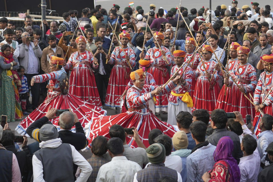 Folk dancers perform for the crowd before a road show by French President Emmanuel Macron and Indian Prime Minister Narendra Modi began in Jaipur, Rajasthan, India, Thursday, Jan. 25, 2024. Macron will be the chief guest at India's annual republic day parade in New Delhi on Friday. (AP Photo/ Deepak Sharma)