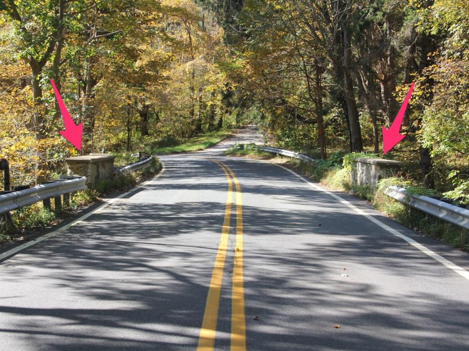 Arrows pointing to barricades on a bridge on Clinton Road.