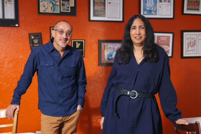 Los Angeles, CA - December 13: Food editor Daniel Hernandez and food manager Laurie Ochoa pose for a portrait at Mariscos Jalisco on Tuesday, Dec. 13, 2022 in Los Angeles, CA. (Dania Maxwell / Los Angeles Times)