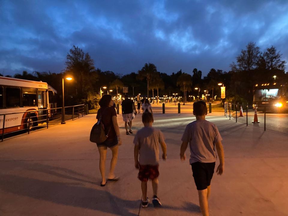 kari and her family walking toward animal kingdom int he morning before the sun is up