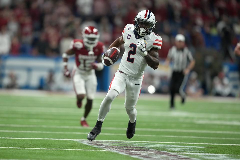 Dec 28, 2023; San Antonio, TX, USA; Arizona Wildcats wide receiver Jacob Cowing (2) scores on a 57-yard touchdown reception against the Oklahoma Sooners in the second half of the Alamo Bowl at Alamodome. Mandatory Credit: Kirby Lee-USA TODAY Sports