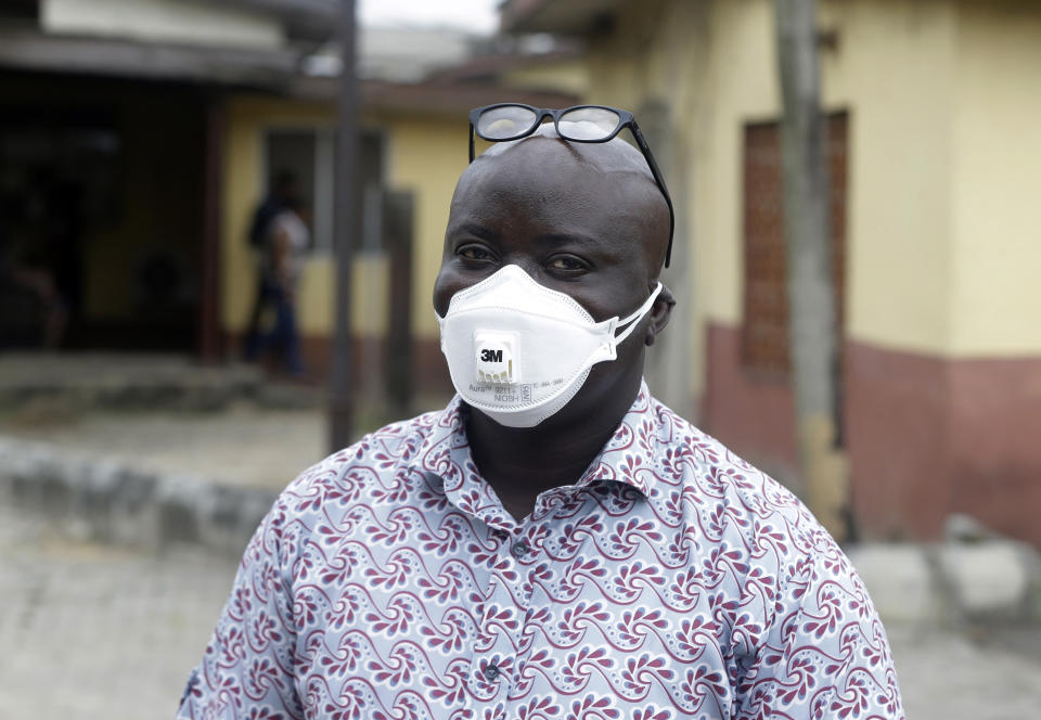 A man wearing a face mask walks outside Yaba Mainland hospital where an Italian citizen - the country's first case of the COVID-19 virus - is being treated, in Lagos, Nigeria Friday, Feb. 28, 2020. Nigeria's health authorities have reported the country's first case of a new coronavirus in Lagos, the first confirmed appearance of the disease in sub-Saharan Africa. (AP Photo/ Sunday Alamba)