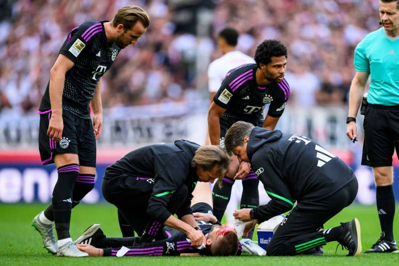 Munich's Eric Dier lies injured on the ground and receives treatment during the German Bundesliga soccer match between VfB Stuttgart and Bayern Munich at MHPArena. Tom Weller/dpa