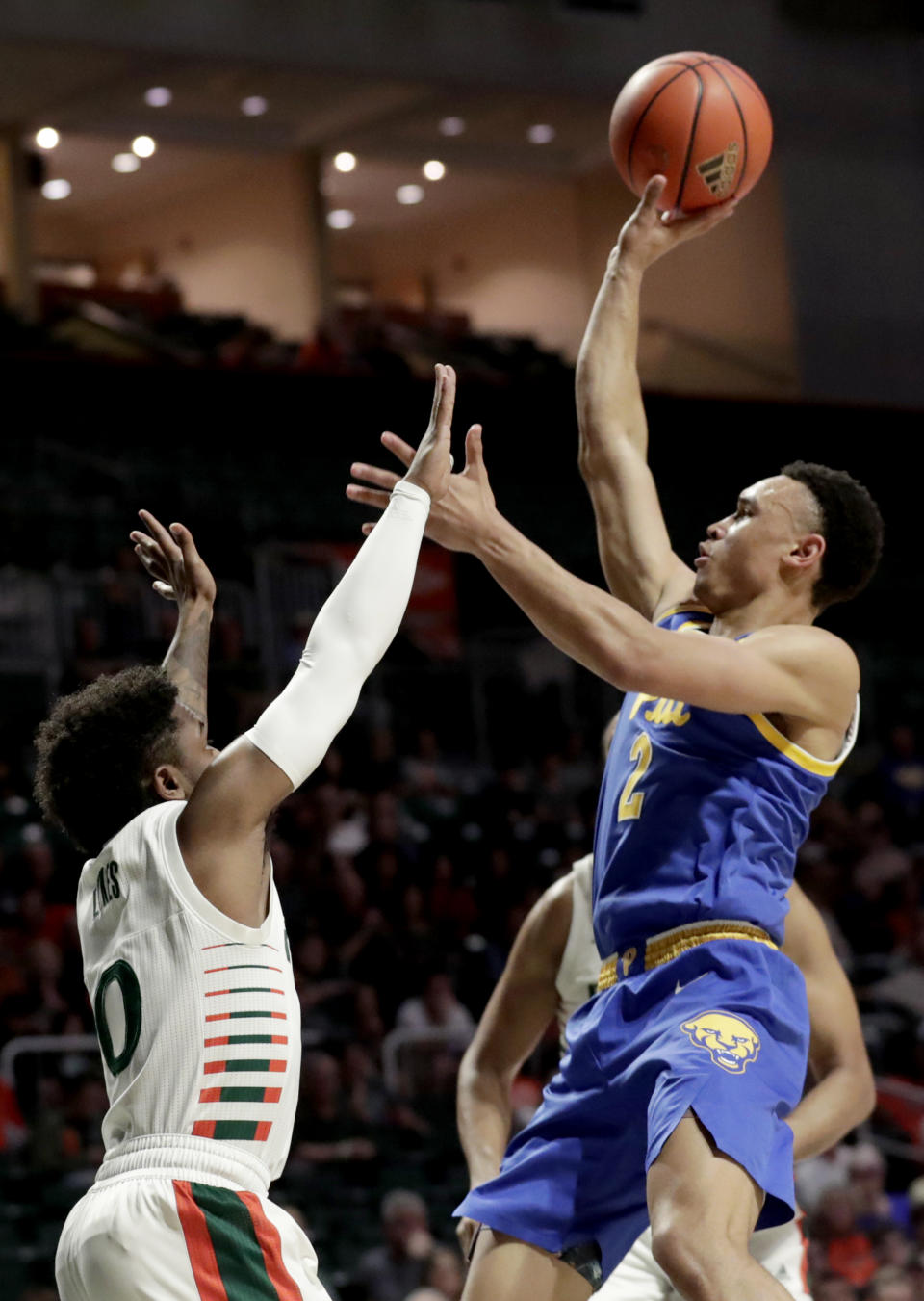 Pittsburgh guard Trey McGowens (2) shoots as Miami guard Chris Lykes (0) defends during the first half of an NCAA college basketball game, Sunday, Jan. 12, 2020, in Coral Gables, Fla. (AP Photo/Lynne Sladky)