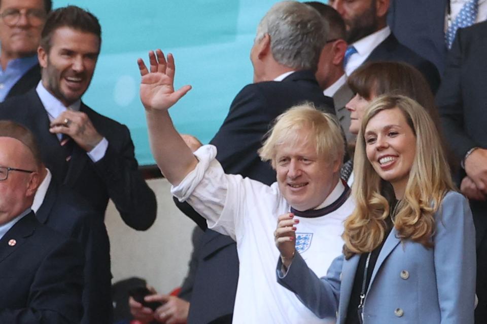 UK Prime Minister Boris Johnson and his spouse Carrie (R), are pictured ahead of the UEFA EURO 2020 semi-final football match between England and Denmark at Wembley Stadium in London on July 7, 2021. (Photo by CARL RECINE / POOL / AFP) (Photo by CARL RECINE/POOL/AFP via Getty Images)