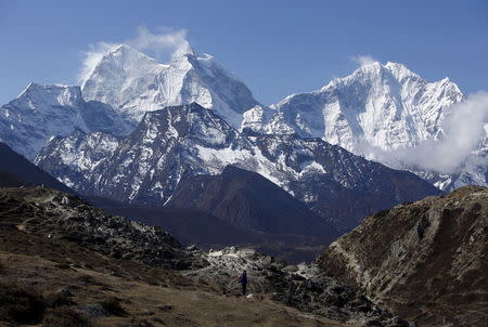 A trekker walks in front of Mount Thamserku while on his way back from Everest base camp near Pheriche in Solukhumbu District, in this file picture taken May 3, 2014. REUTERS/Navesh Chitrakar