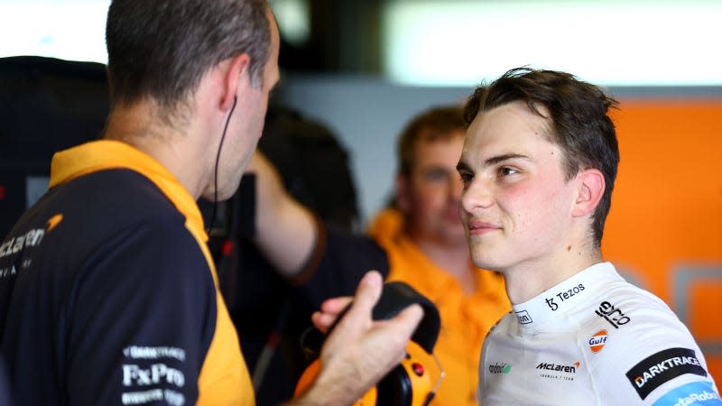 A photo of Oscar Piastri in the McLaren garage at testing. 