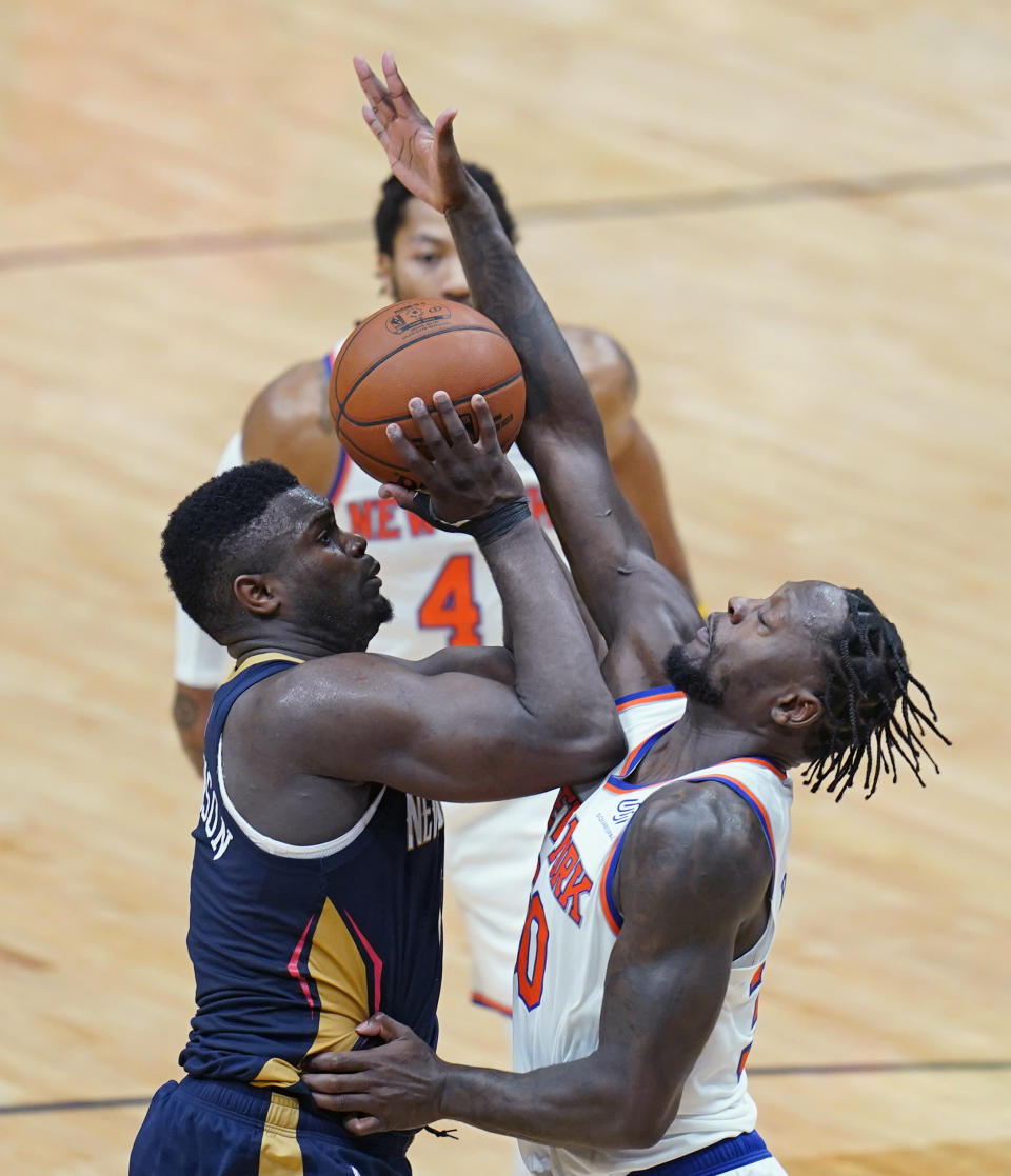 New Orleans Pelicans forward Zion Williamson is fouled has he goes to the basket against New York Knicks forward Julius Randle in the second half of an NBA basketball game in New Orleans, Wednesday, April 14, 2021. The Knicks won 116-106. (AP Photo/Gerald Herbert)