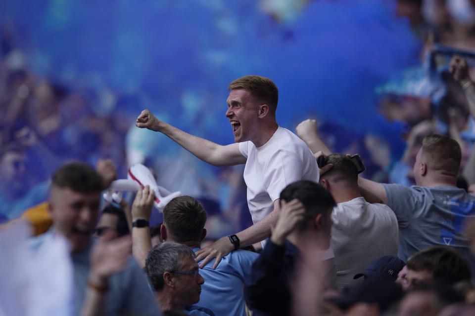 Manchester City fans celebrate after Ilkay Gundogan scores his side's opening goal during the English FA Cup final soccer match between Manchester City and Manchester United at Wembley Stadium in London, Saturday, June 3, 2023. (AP Photo/Dave Thompson)
